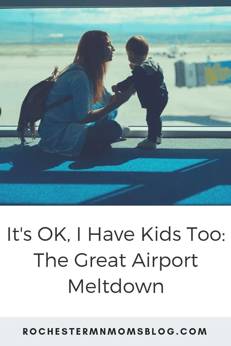 mom kneeling by toddler in airport