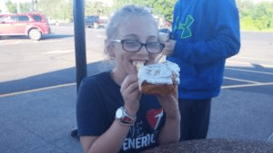 girl eating cinnamon roll