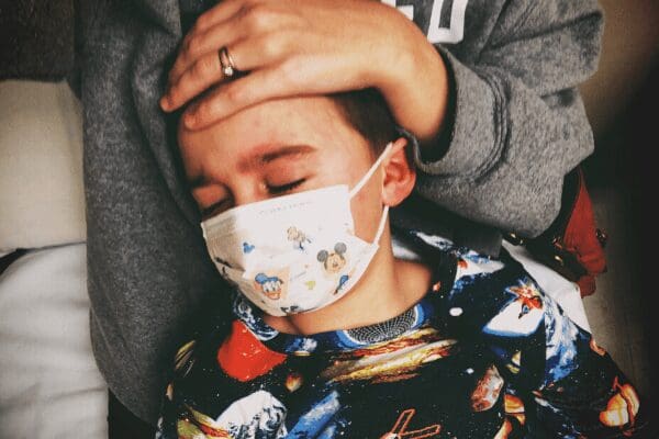 mother holding sick son