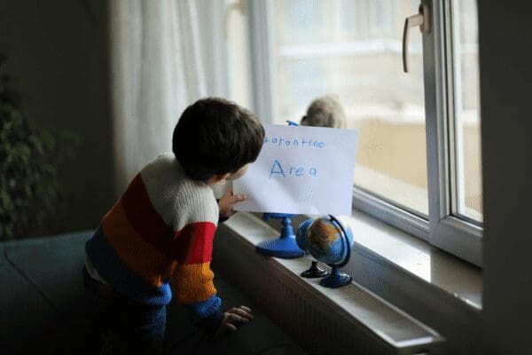 child at home playing near window