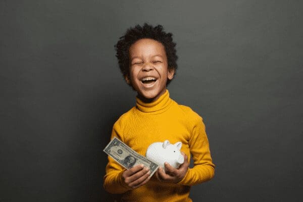 child with money & piggy bank