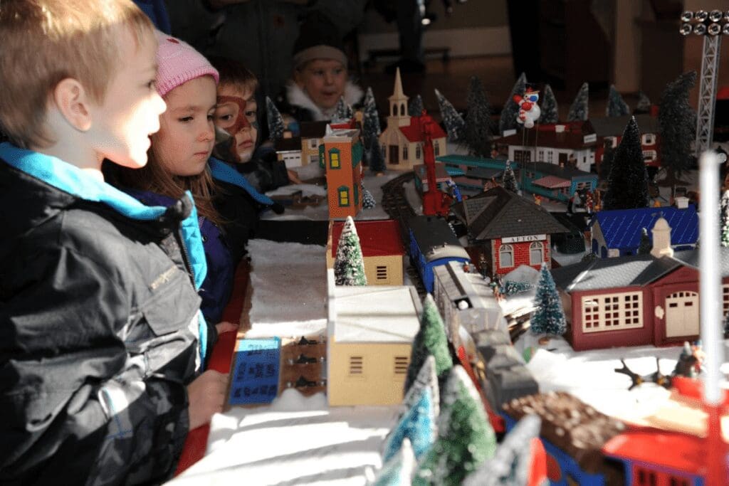 Children looking at a model train during Afton Village Holiday in Afton, MN