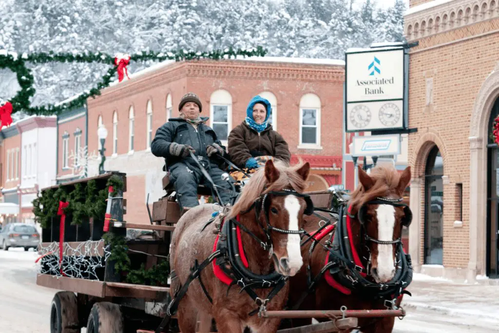People in a horse-drawn wagon during the Christmas season in downtown Lanesboro, MN