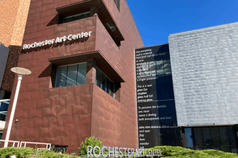 Ascend poem by Erin Sharkey, visible on the front windows of the Rochester Art Center. 